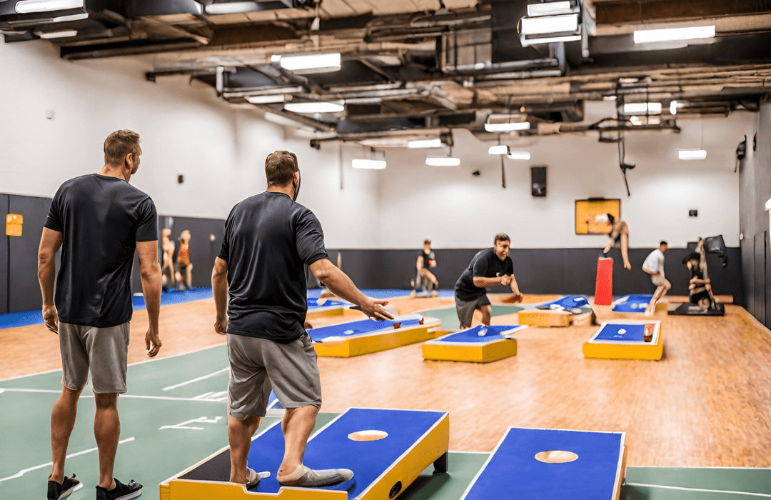 Players playing Corn Hole at anytime courts in an indoor sports court